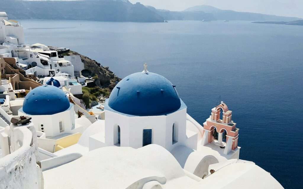 Oia's blue-domed churches above the Santorini caldera